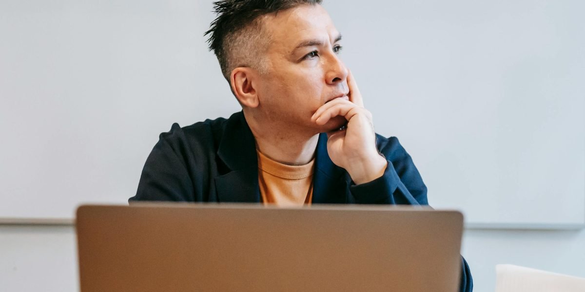 An individual thoughtfully considering various funding paths for a new business endeavor.