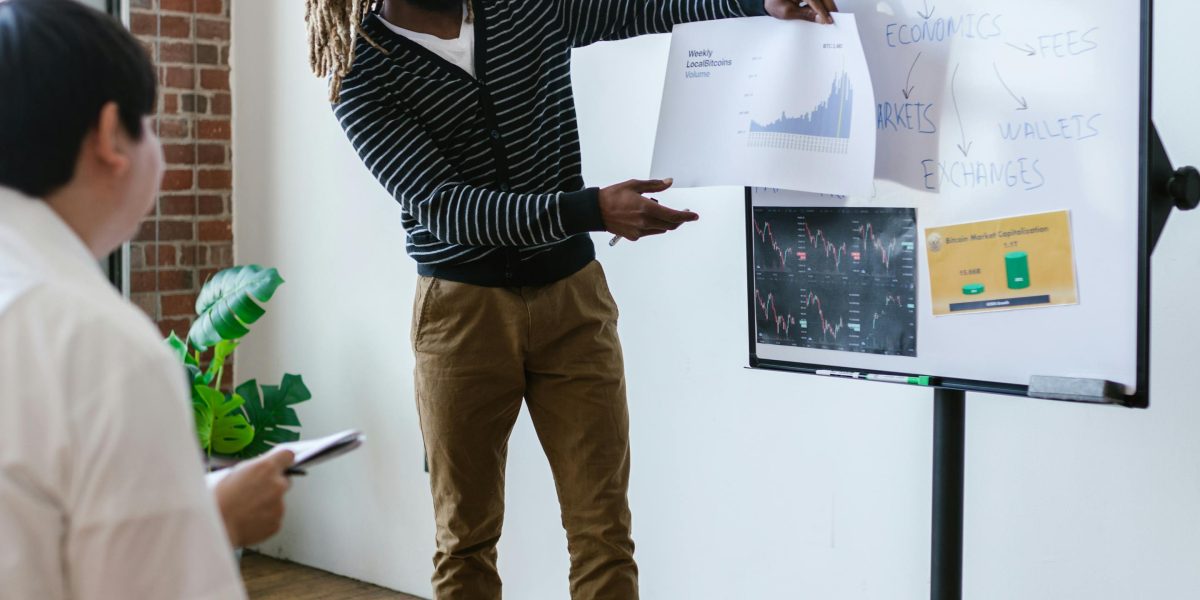 An entrepreneur outlining strategic growth goals and control preferences on a whiteboard.