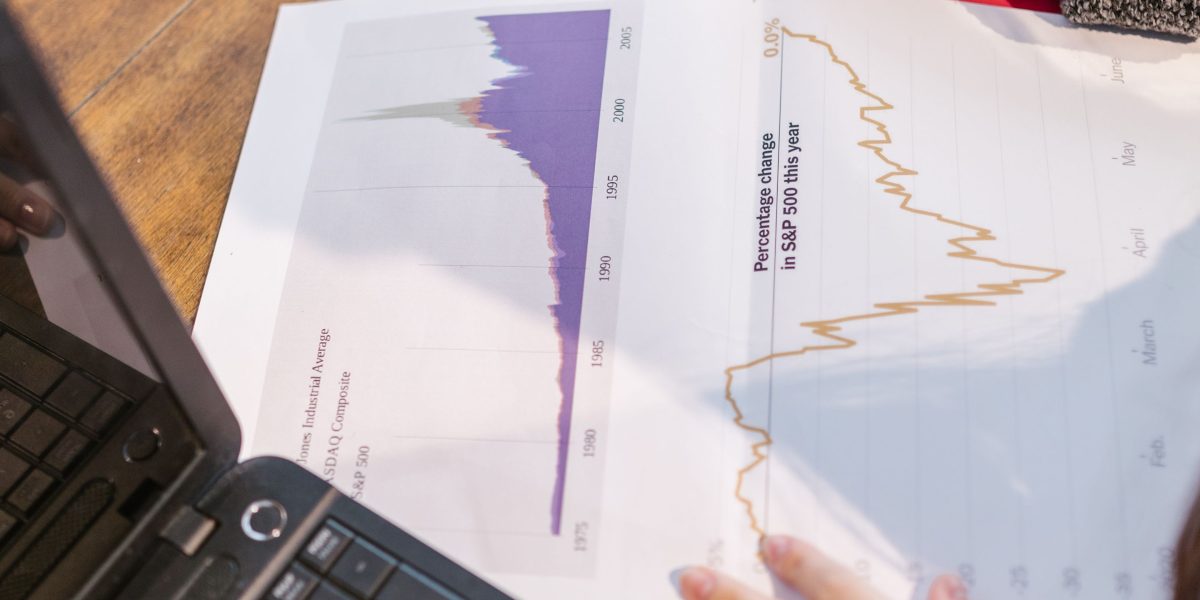 An individual reviewing documents or reports, focused on identifying market trends and opportunities.