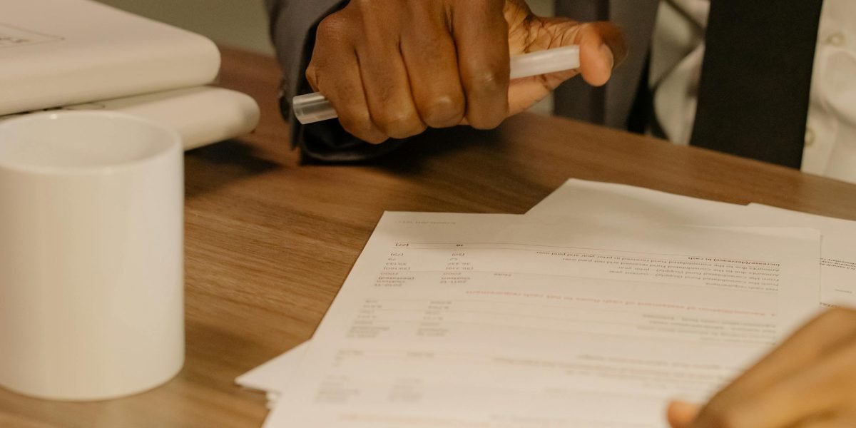 A professional meticulously reviews documents, embodying the critical human oversight needed to validate AI-generated outputs.