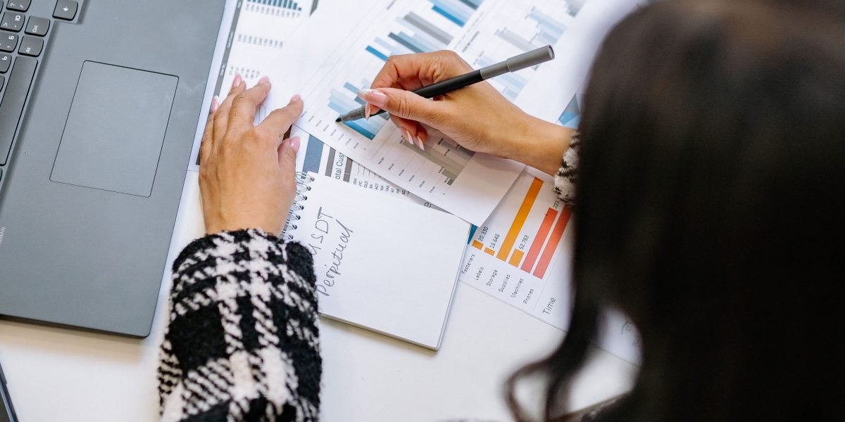 A professional thoughtfully analyzing business reports and data to assess performance and ROI.