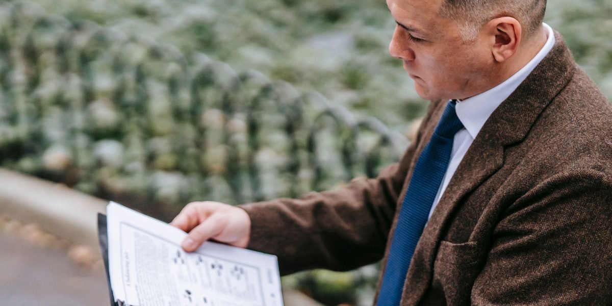 An investor meticulously reviews documents and plans as part of their due diligence process for AI startups.