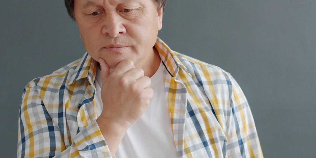 A person looking thoughtfully at multiple options, symbolizing the challenge of choosing AI tools.
