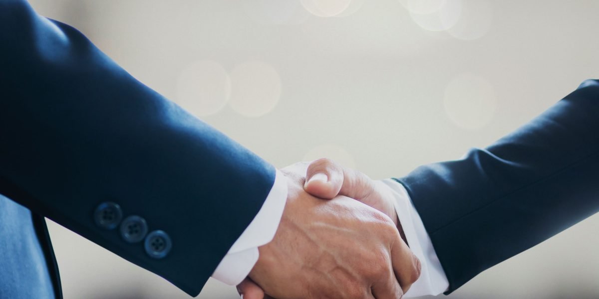 Two professionals shaking hands after a successful meeting, representing finalized deals or successful partnerships facilitated by data.