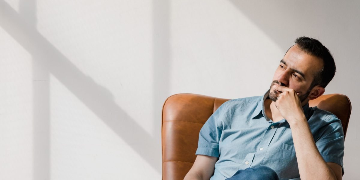 A person reflecting on the challenges of running a business without modern digital tools.