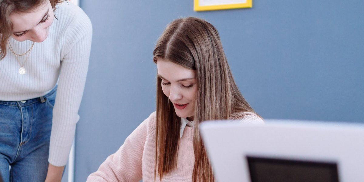 An experienced professional provides guidance to a younger colleague, fostering growth.