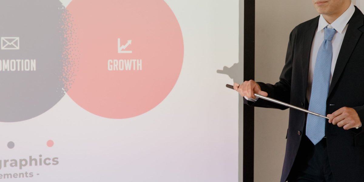 A professional presenting a business strategy, representing the journey of taking foundational AI ideas from theory to successful products.