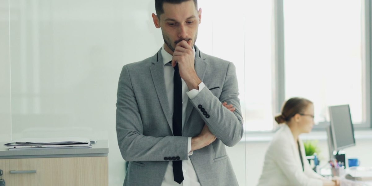 A person carefully weighing options, representing the meticulous process of selecting the right investment partners.
