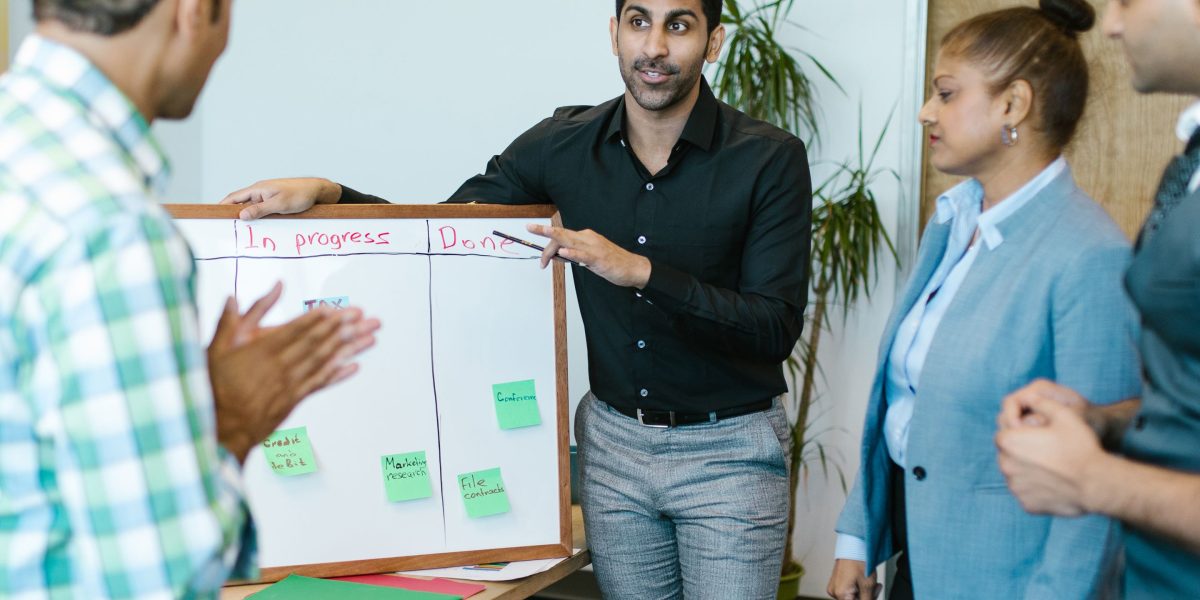 A team collaborates in a meeting room, strategizing business growth and data utilization.