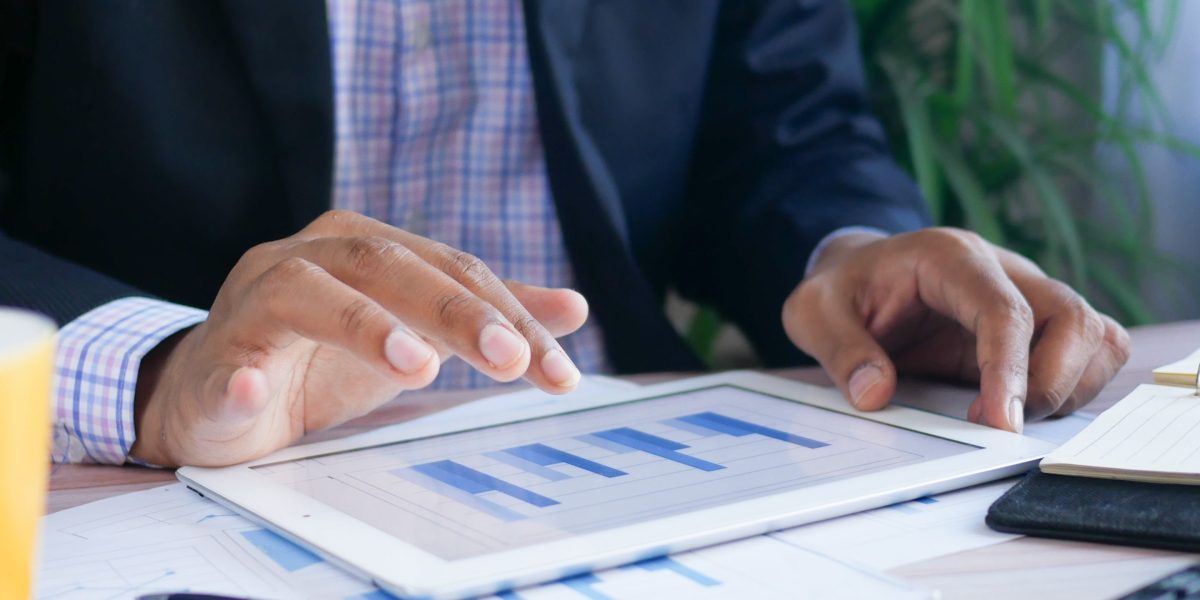 A person analyzing business reports, symbolizing the process of finding valuable insights in complex data.