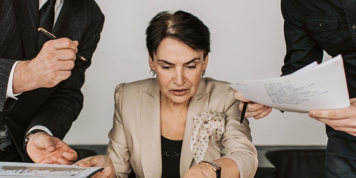 Two business partners collaborating and reviewing a document, signifying the process of choosing strategic allies.