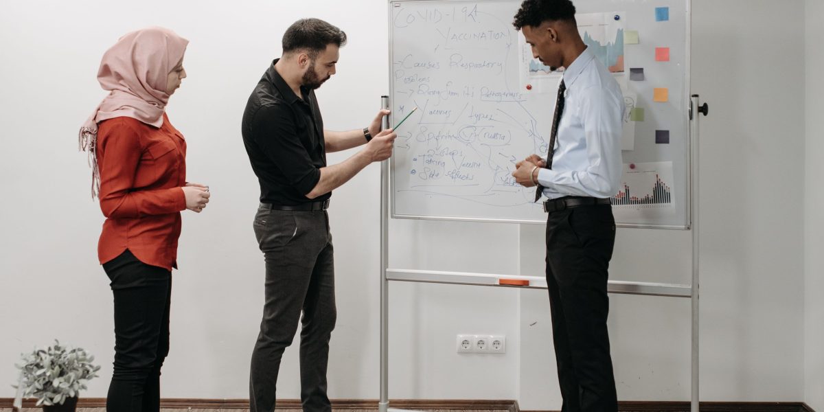A diverse team working together on a project, symbolizing the talent and ideas fostering growth in a hi tech city.