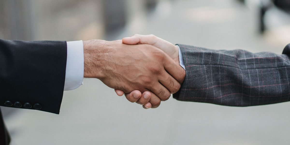 A handshake signifying a successful partnership or investment deal between businesses in a thriving tech hub.