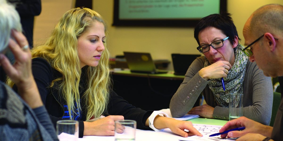 Professionals engaged in a productive meeting, discussing team structure or partnerships.