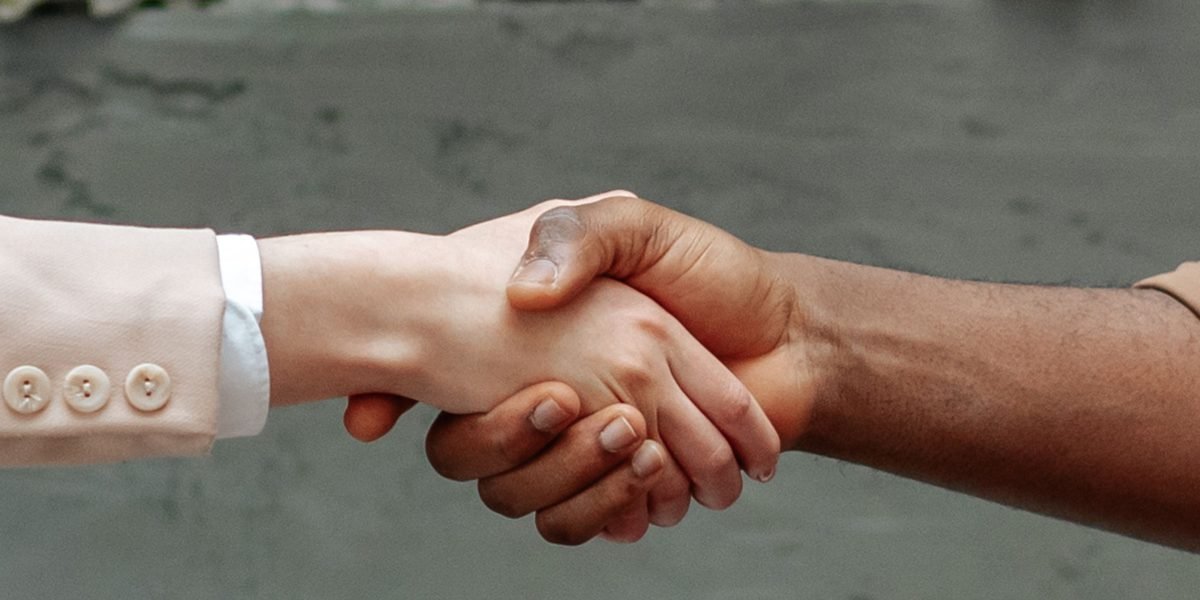 Professionals shaking hands, symbolizing a successful partnership or collaboration.
