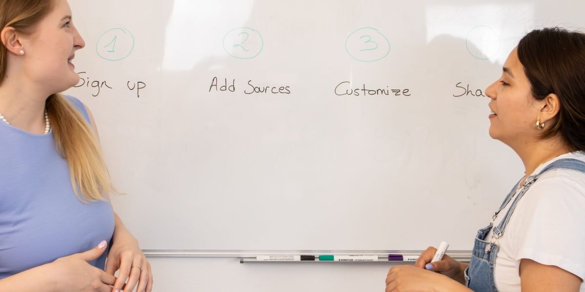 Professionals collaborating on a whiteboard, strategizing and brainstorming new business ideas.
