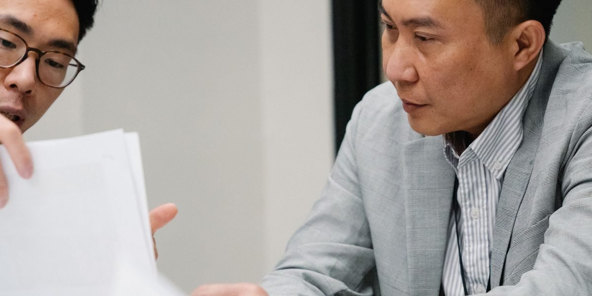 A person reading and concentrating on important documents at a desk, emphasizing careful review.