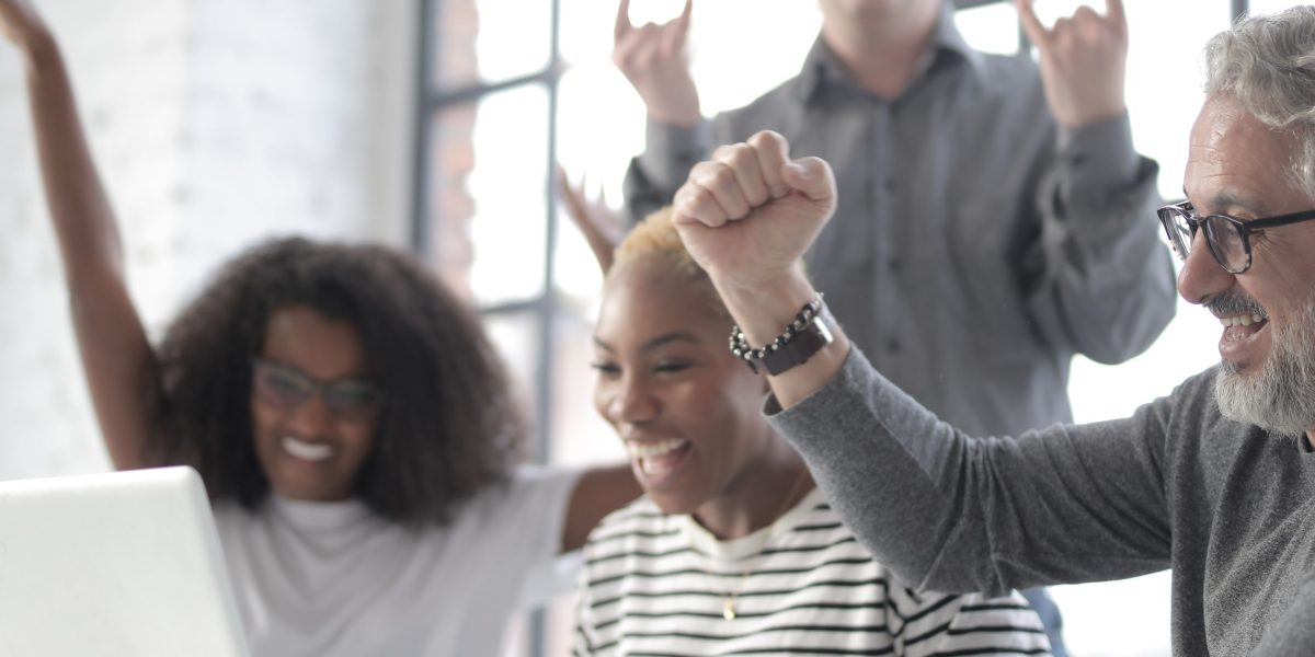 A team celebrates achieving project milestones and successful pilot outcomes.