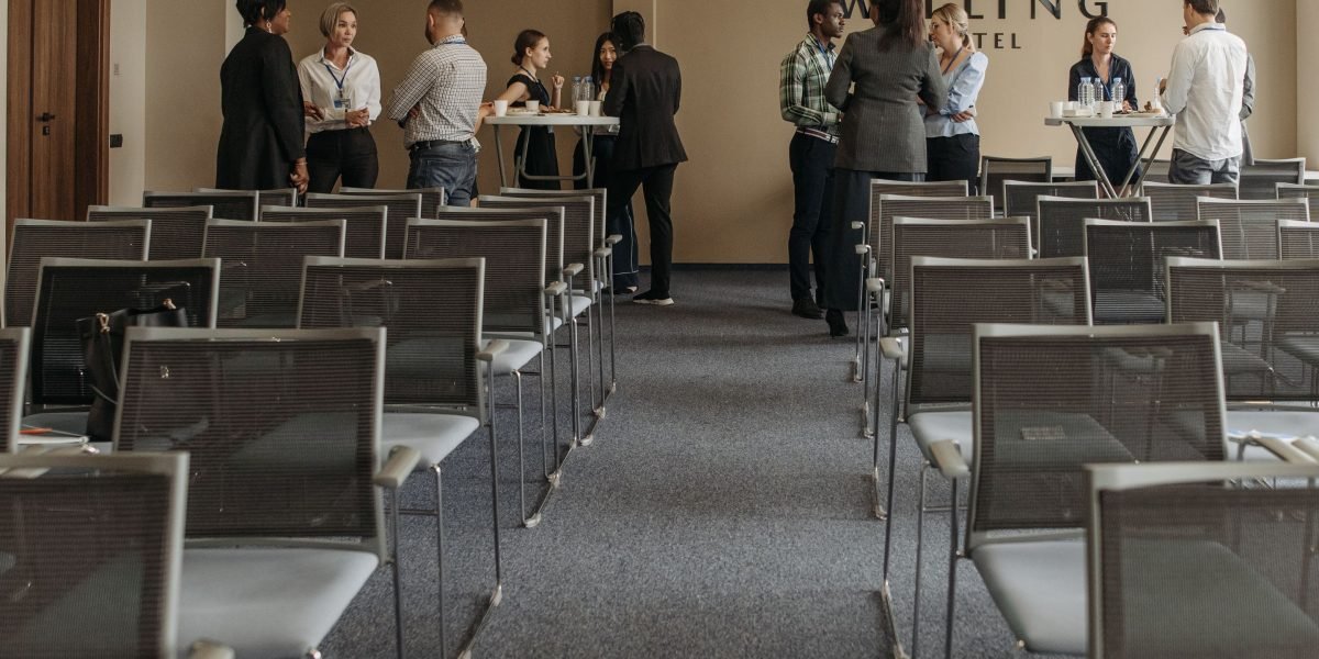 Professionals engage in conversation, building connections at an industry event.