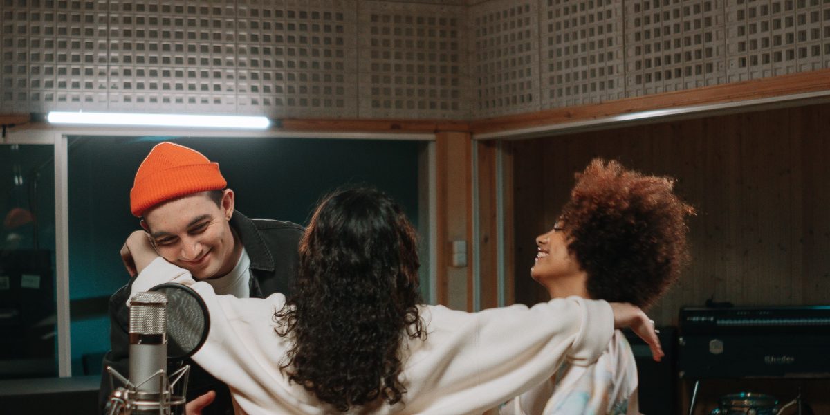A creative team collaborates in a music studio, reflecting Harbourview Equity's focus on entertainment and media assets.