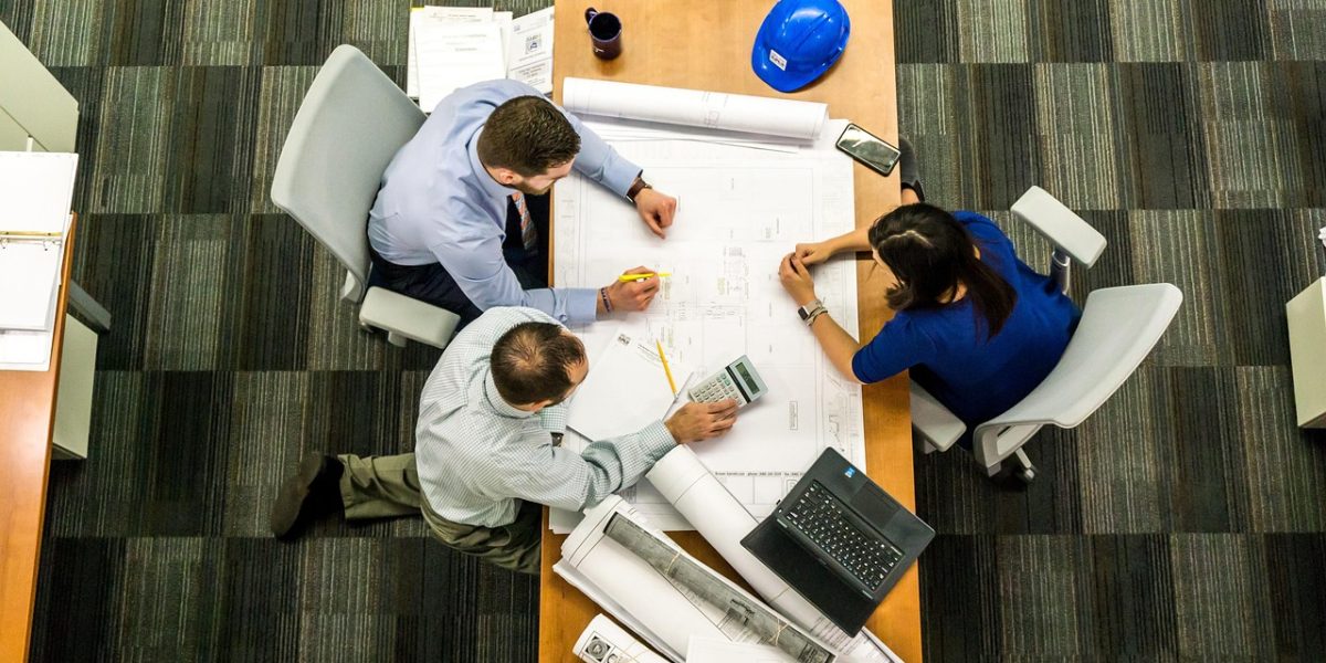 A team collaboratively analyzing financial data, highlighting the importance of detailed directory information.