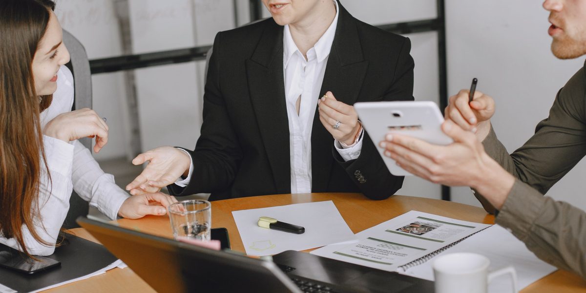 Executives in a modern office environment engaged in a serious discussion, symbolizing the challenges of strategic decision-making.