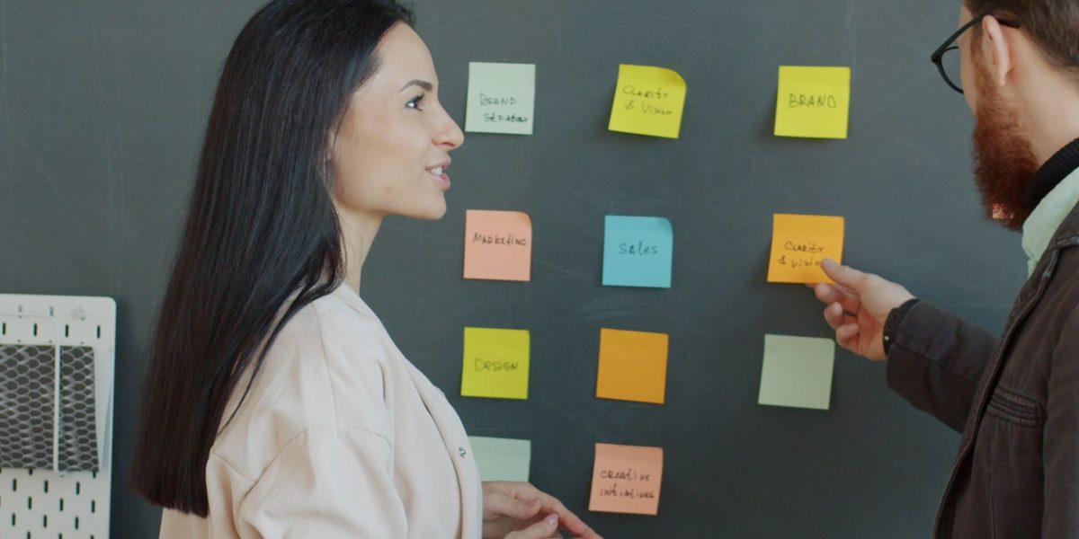 A manager carefully reviewing documents and making critical decisions for business growth.
