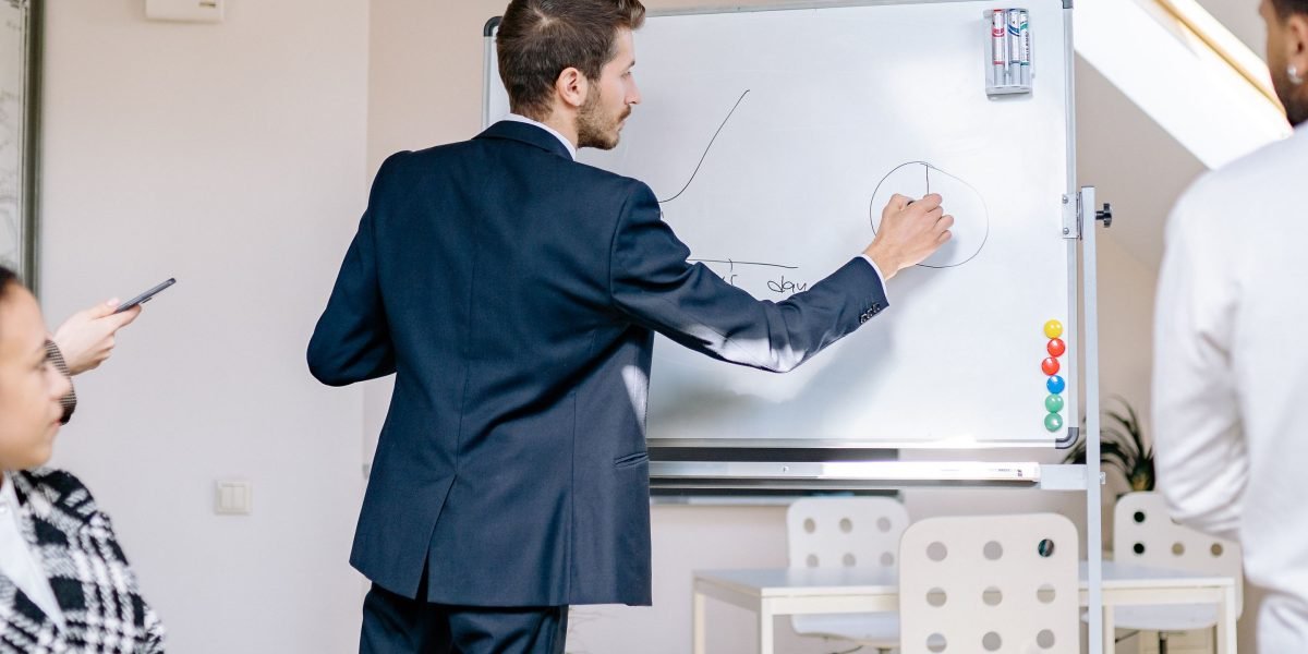 Professionals collaborate on strategy, symbolizing the forward-thinking approach needed in business and investment decisions.