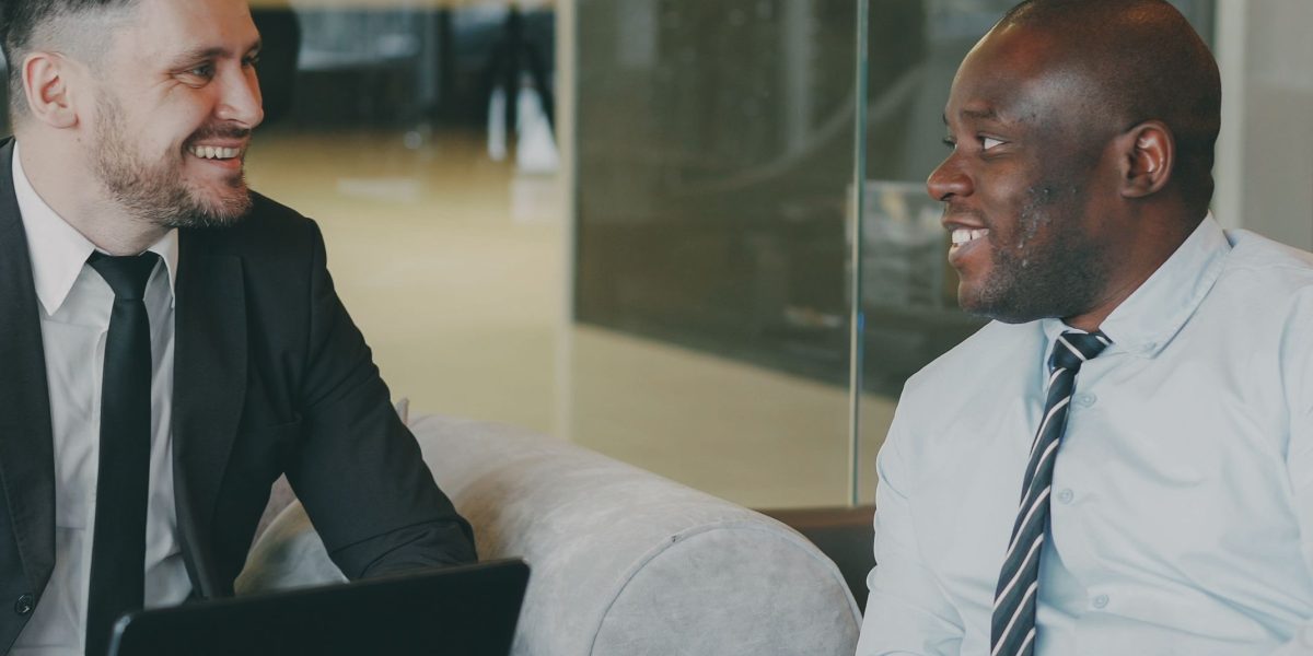 A mentor guiding a professional, reflecting Arsenal Capital Partners' hands-on approach to fostering leadership and growth in their portfolio companies.