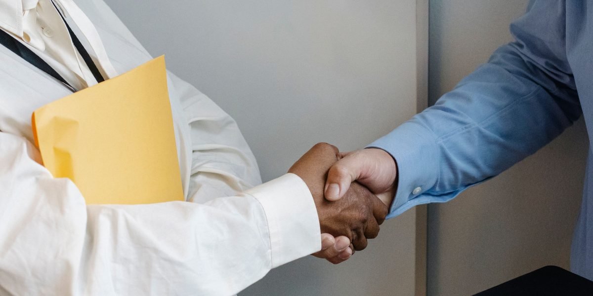 A scene depicting a handshake, symbolizing the successful closing of a significant business deal or partnership.
