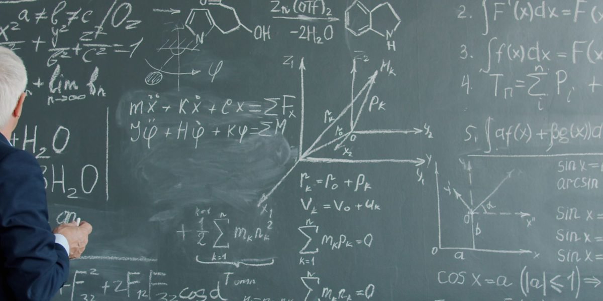 A person focused on a whiteboard, symbolizing the effort to grasp fundamental mathematical concepts for data science.