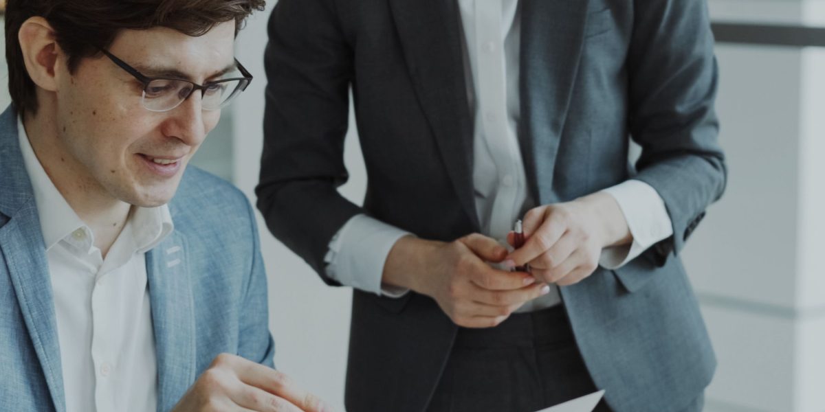 An investor carefully reviews documents, representing the due diligence process for assessing a startup's data capabilities.